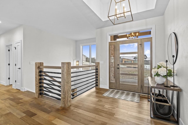 foyer featuring an inviting chandelier and hardwood / wood-style flooring