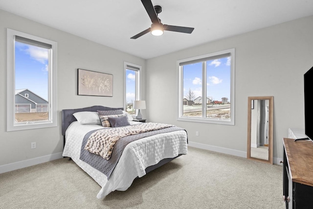 bedroom with ceiling fan and light carpet