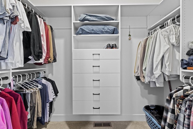 walk in closet with carpet