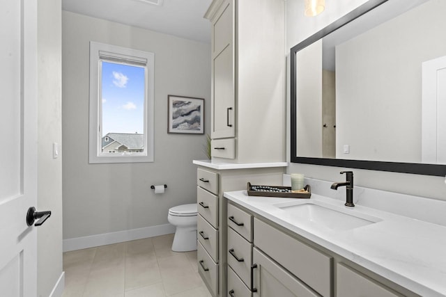 bathroom featuring toilet, tile patterned floors, and vanity