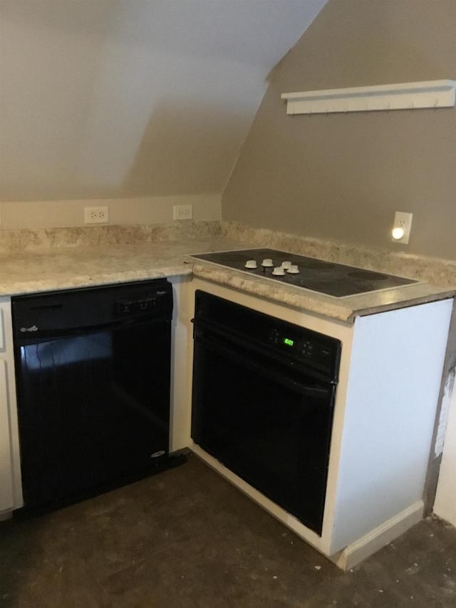 kitchen featuring white cabinets, black appliances, and lofted ceiling