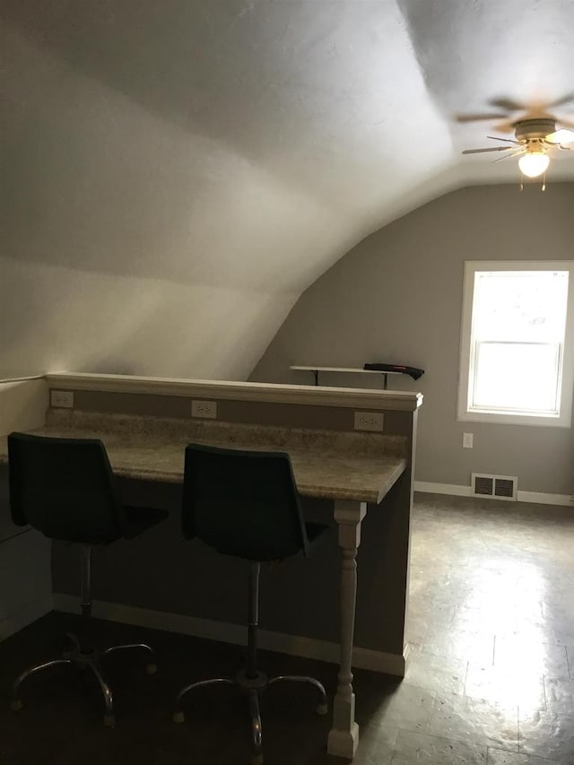 bar with ceiling fan and lofted ceiling