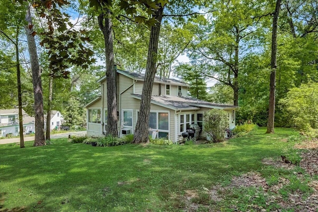 rear view of house with a lawn