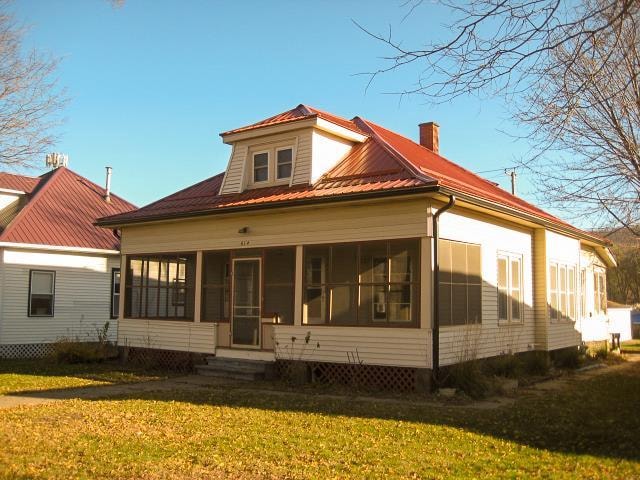 back of house featuring a sunroom and a yard