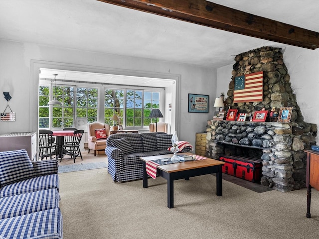 carpeted living room featuring beam ceiling and a fireplace