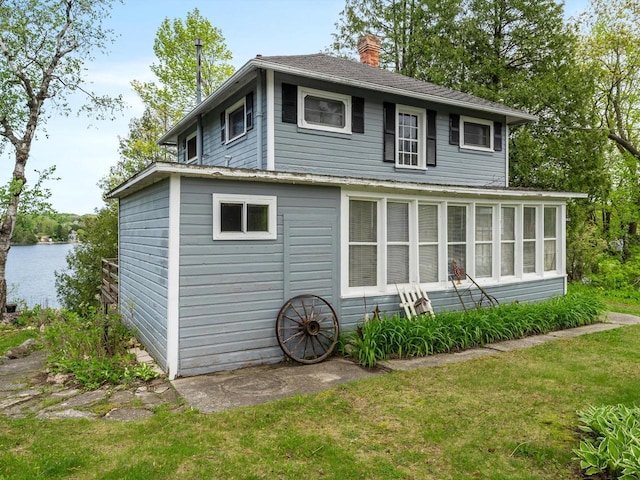 W6540 County Road C, Plymouth, WI 53073 - back of property featuring a chimney, a lawn, and a water view