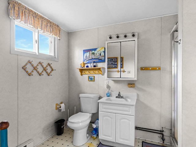 bathroom with vanity, toilet, and baseboard heating