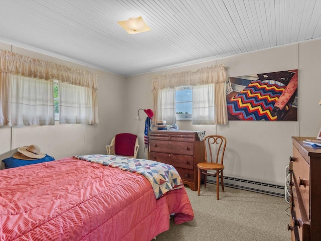 carpeted bedroom featuring a baseboard heating unit