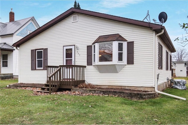 back of house with a lawn