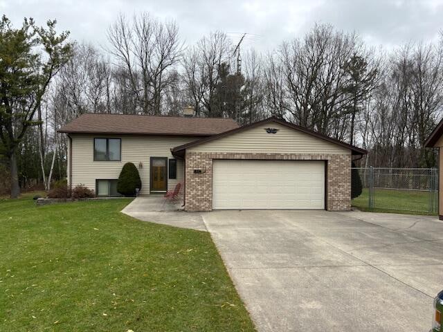 view of front of home with a garage and a front lawn