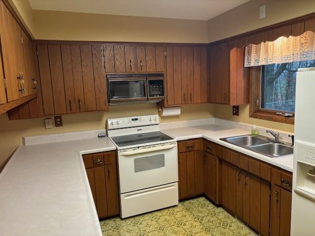 kitchen with white range with electric cooktop and sink