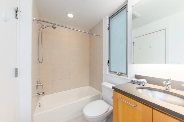 full bathroom with vanity, toilet, and tiled shower / bath combo