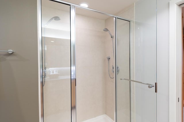 bathroom with a shower with door