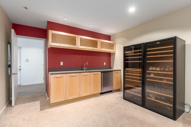 kitchen featuring sink, light brown cabinetry, light carpet, and wine cooler