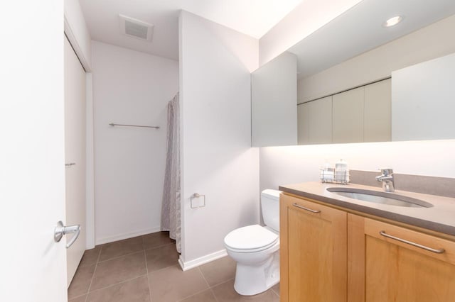 bathroom featuring toilet, vanity, and tile patterned floors