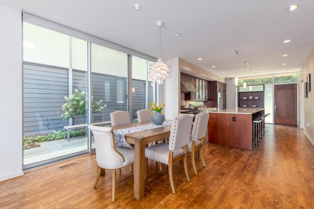 dining room with expansive windows and dark hardwood / wood-style flooring