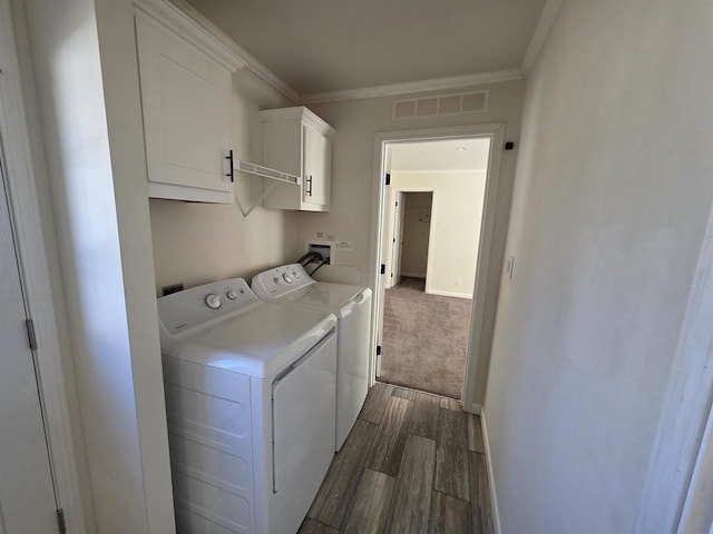 1407 N Peach Ave Unit 119, Marshfield, WI 54449 - washroom with cabinet space, separate washer and dryer, dark wood-type flooring, and crown molding