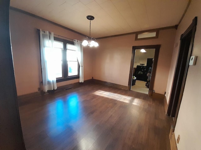 unfurnished dining area with a notable chandelier, dark hardwood / wood-style floors, and crown molding