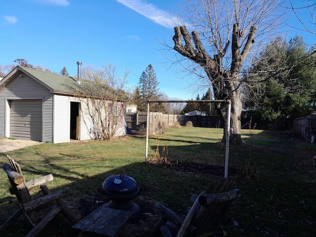 view of yard with a garage and an outdoor structure