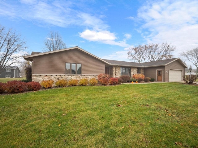 ranch-style house featuring a front yard and a garage