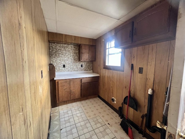 bathroom with tasteful backsplash and wooden walls