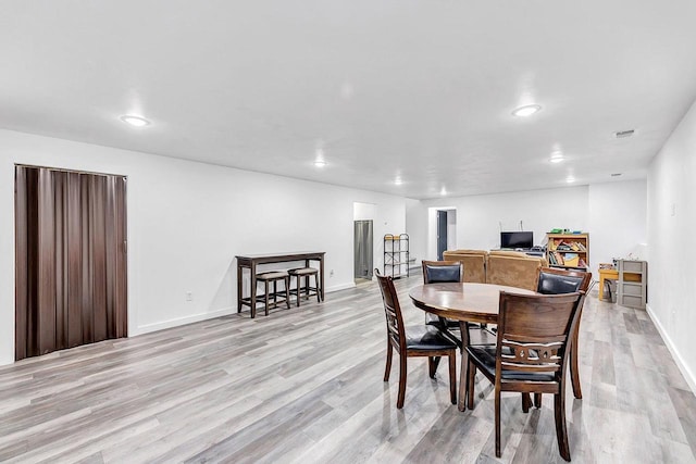 dining space with light hardwood / wood-style flooring