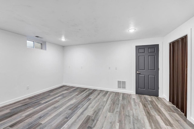 basement with light hardwood / wood-style floors