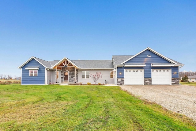 view of front of property with a garage and a front lawn