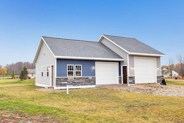 view of front of house with a garage and a front lawn