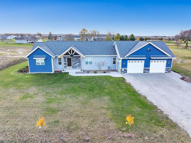 single story home featuring a garage and a front lawn