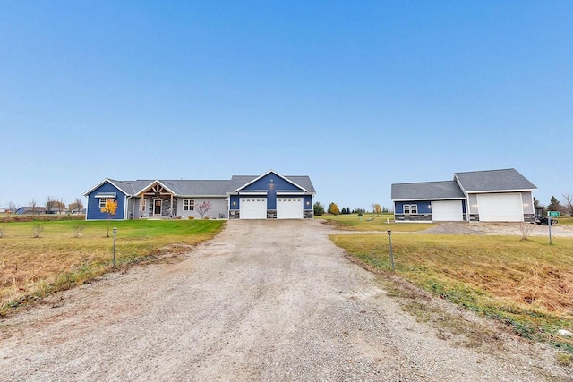 single story home featuring a garage and a front lawn