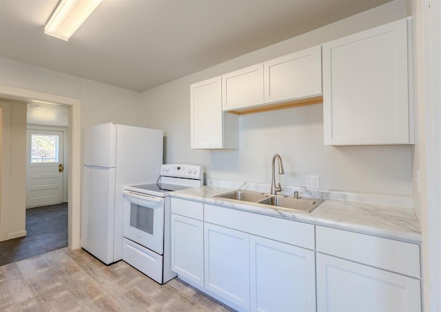 kitchen with white cabinetry, sink, light stone counters, white appliances, and light wood-type flooring