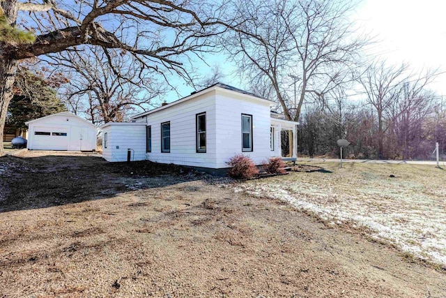 view of front of house featuring a garage and an outdoor structure