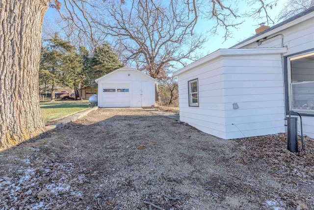 view of home's exterior featuring an outbuilding and a garage