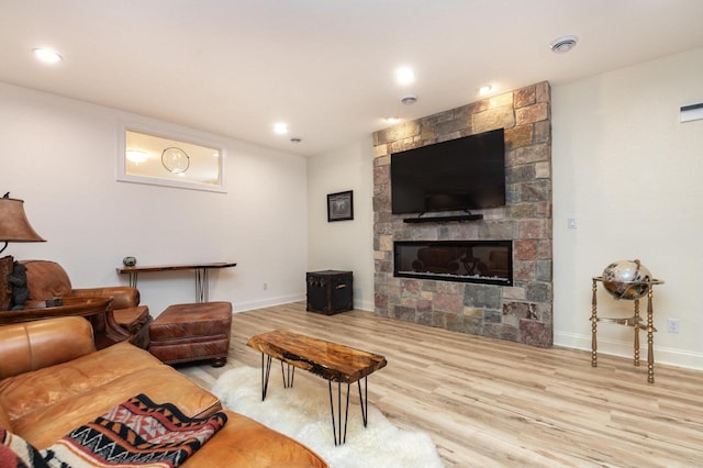 living room with a fireplace and light hardwood / wood-style flooring