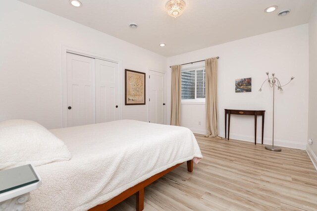 bedroom featuring light wood-type flooring and a closet