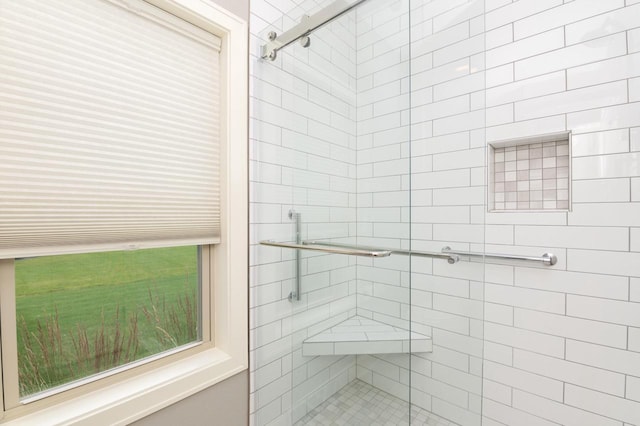 bathroom featuring a shower with shower door