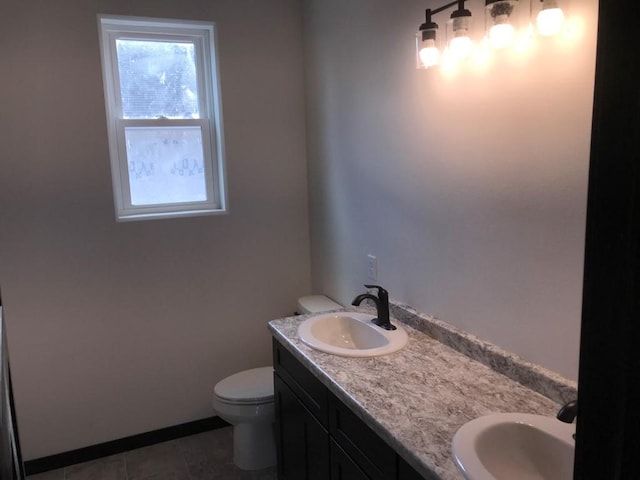 bathroom with tile patterned floors, vanity, and toilet