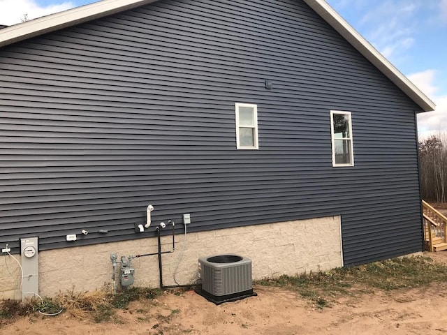 view of side of property featuring central AC unit