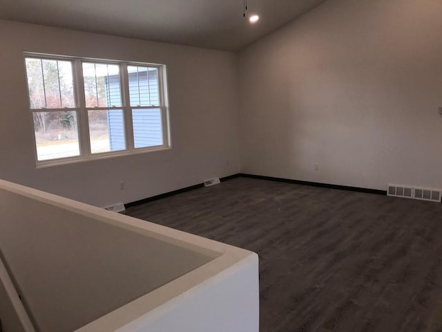 unfurnished room featuring dark hardwood / wood-style flooring