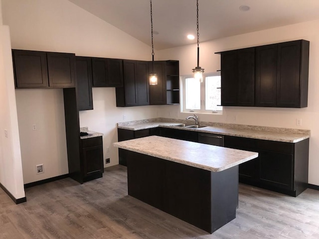 kitchen featuring sink, pendant lighting, light hardwood / wood-style floors, a kitchen island, and lofted ceiling