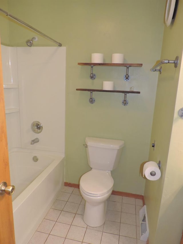 bathroom featuring tile patterned flooring, shower / bathing tub combination, and toilet