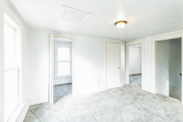 unfurnished bedroom featuring light colored carpet