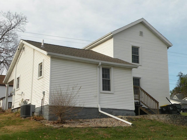 rear view of property with central AC