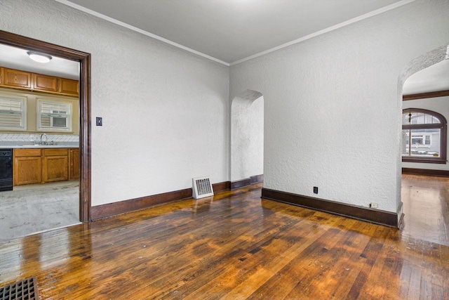 interior space with crown molding, dark wood-type flooring, and sink