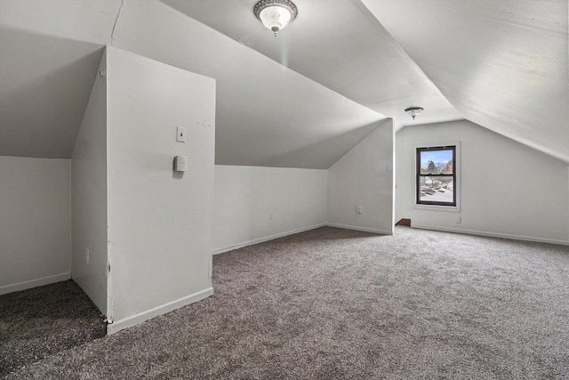 bonus room with carpet flooring and vaulted ceiling