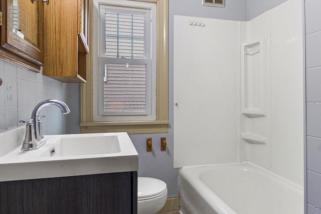 full bathroom featuring backsplash, shower / tub combination, vanity, and toilet