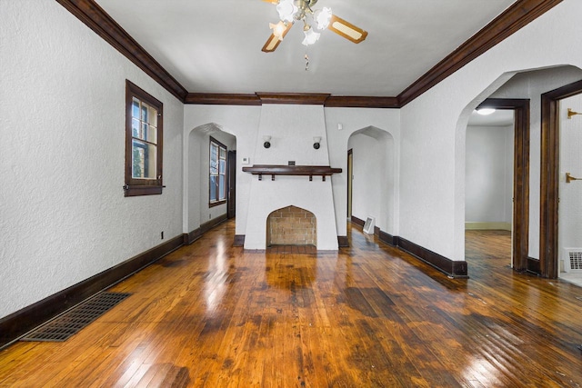 unfurnished living room with dark hardwood / wood-style floors, ceiling fan, and crown molding