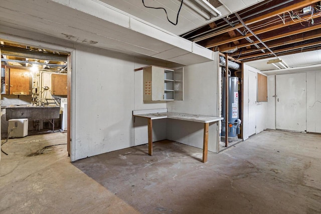 basement with a workshop area and water heater