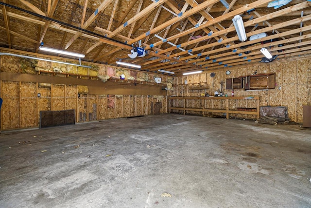 garage with a workshop area and a garage door opener